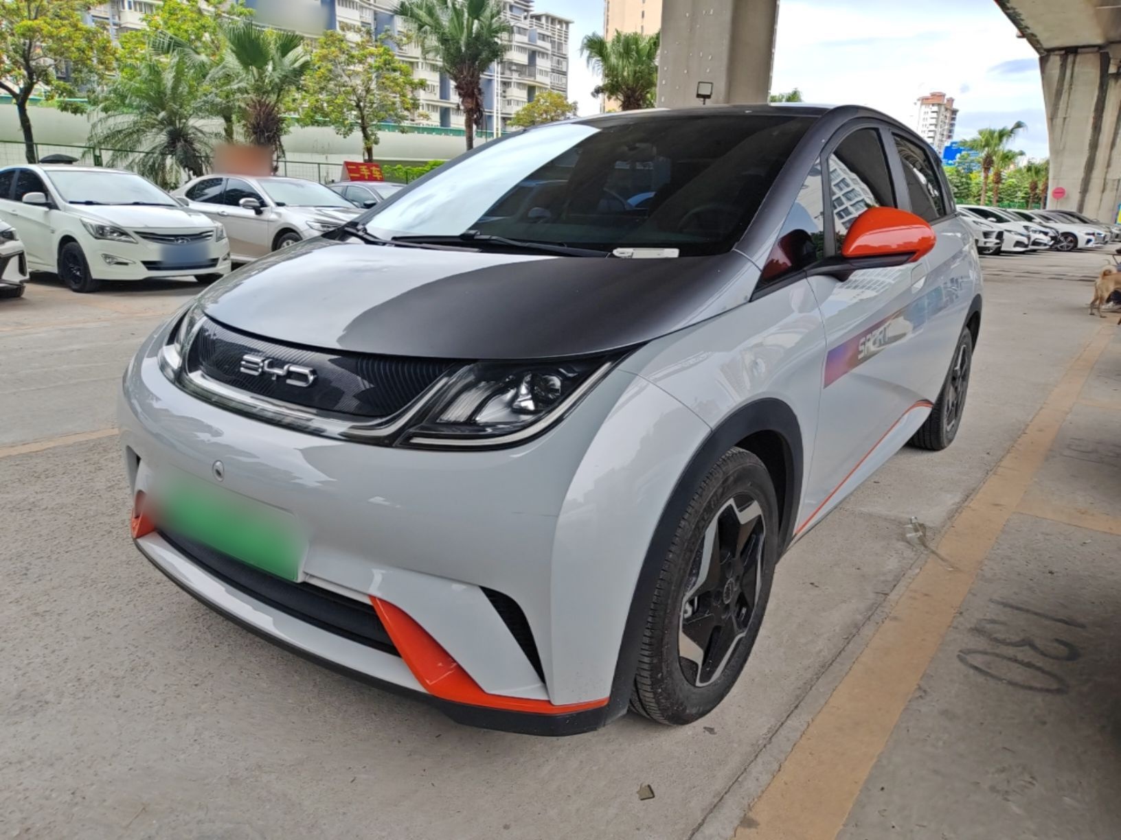 Under the front of the car