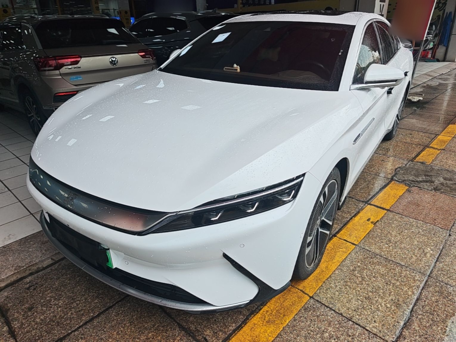 Under the front of the car