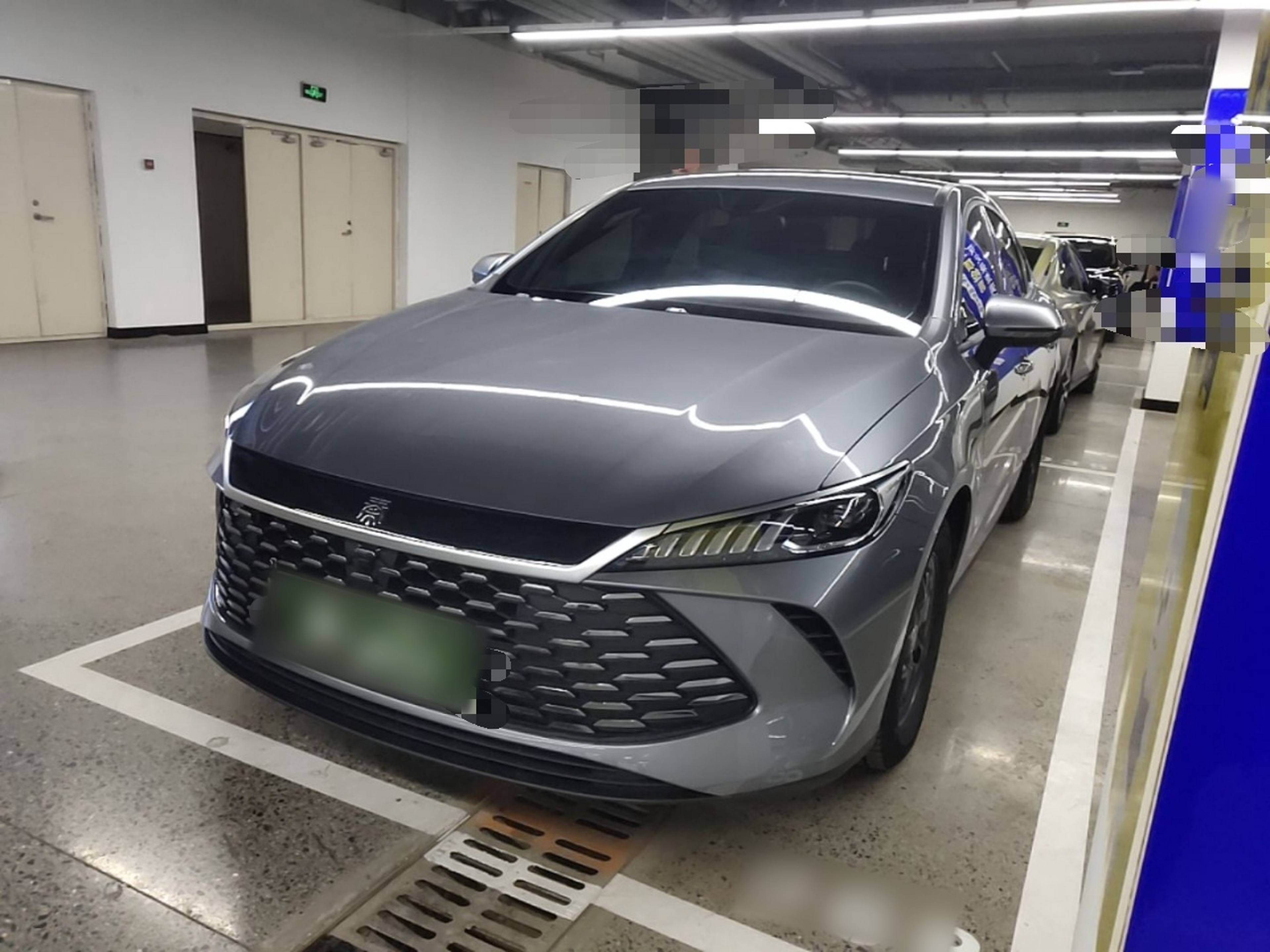 Under the front of the car