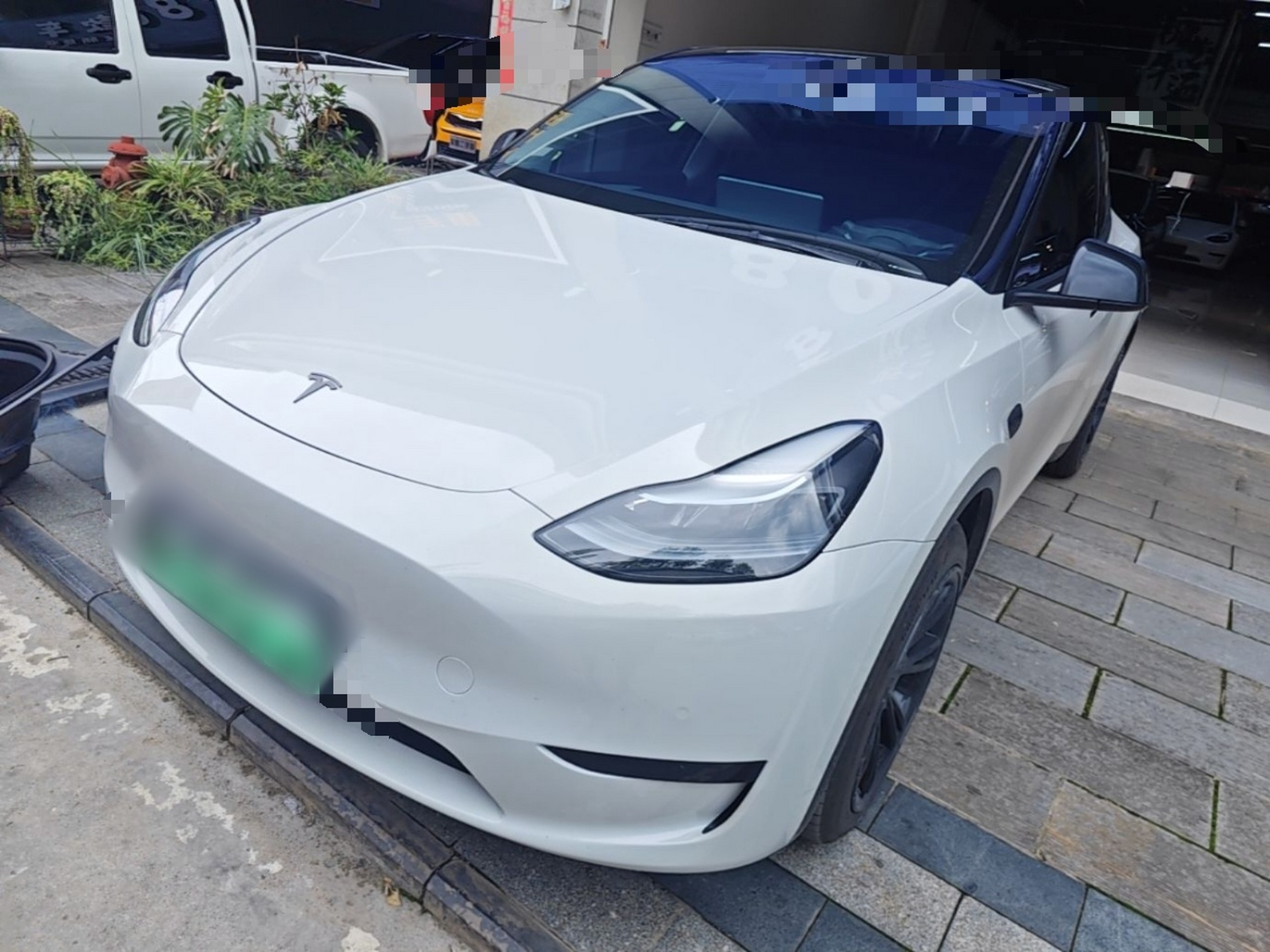 Under the front of the car