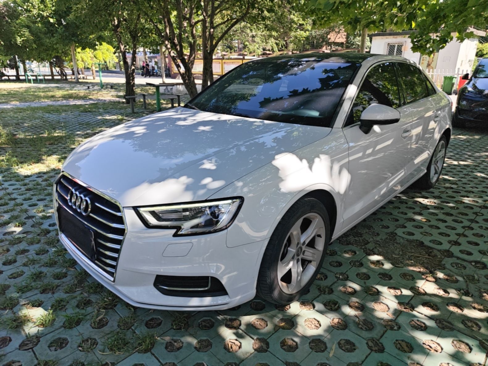 Under the front of the car
