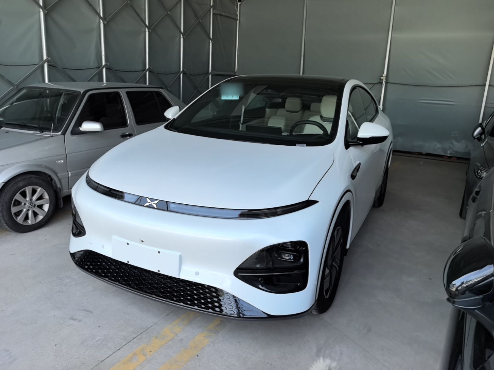 Under the front of the car