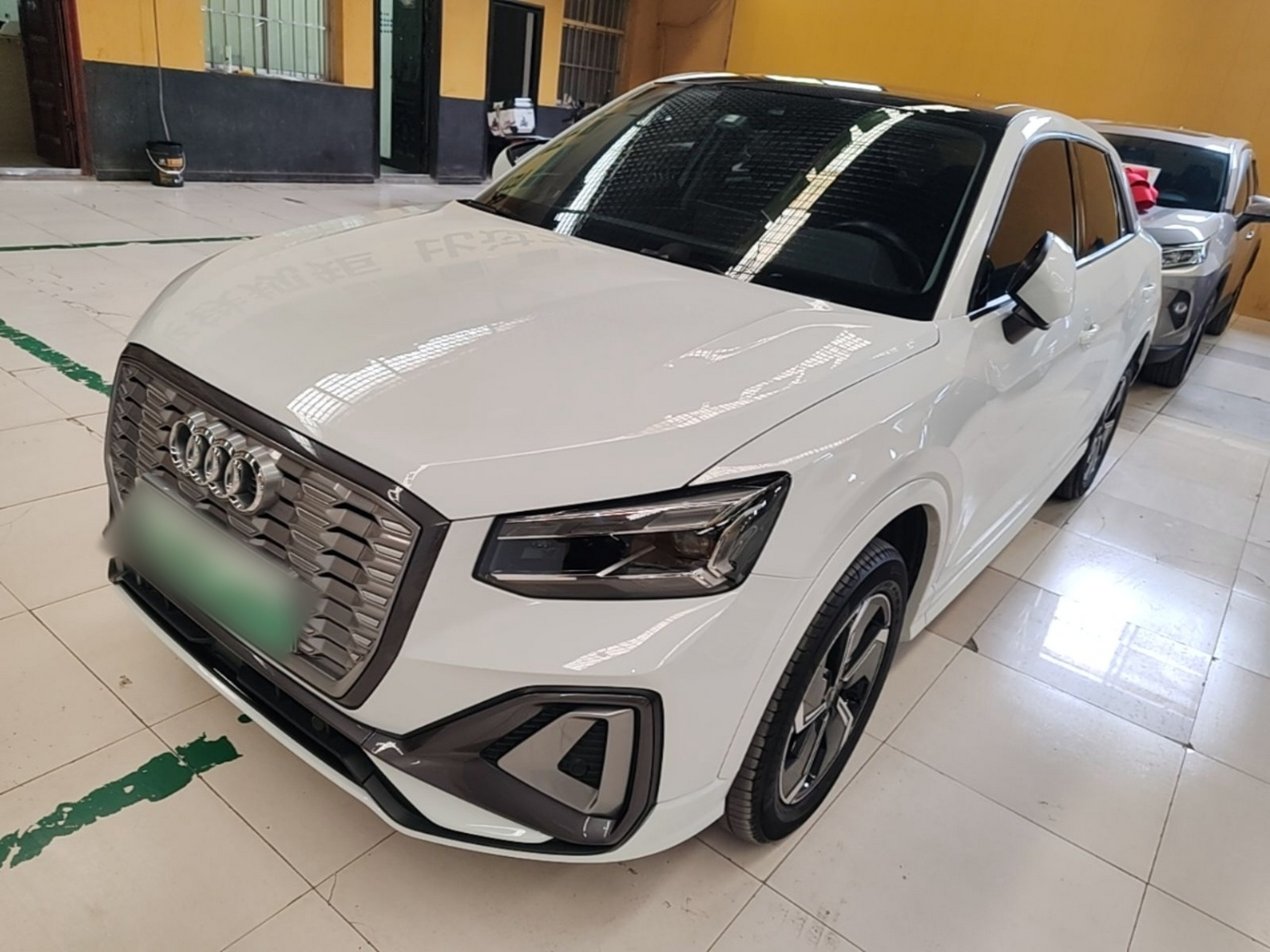 Under the front of the car