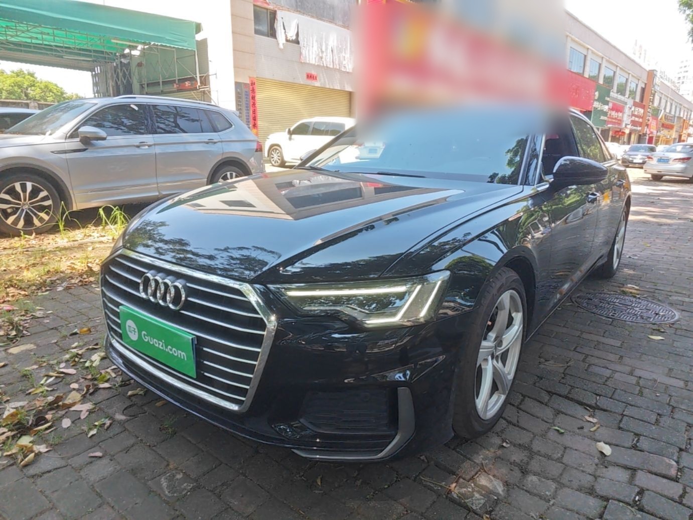 Under the front of the car