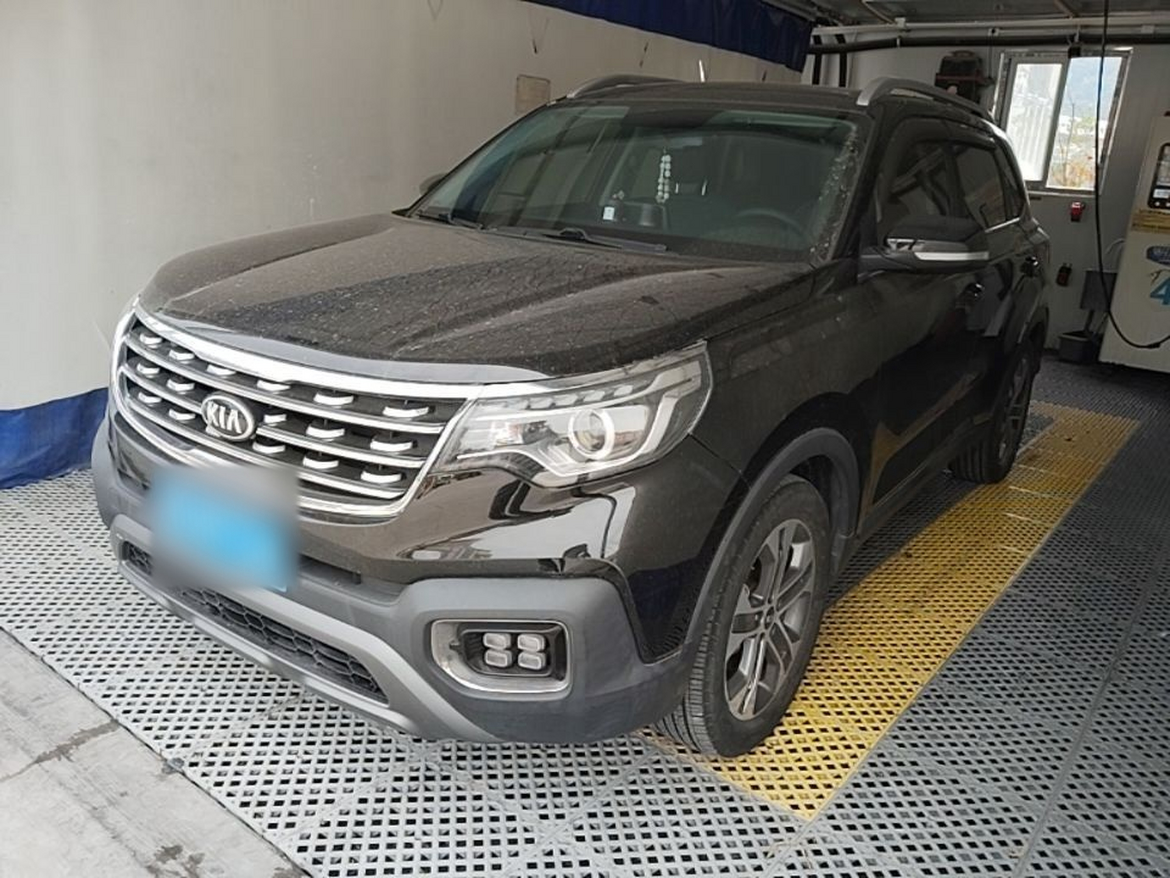 Under the front of the car