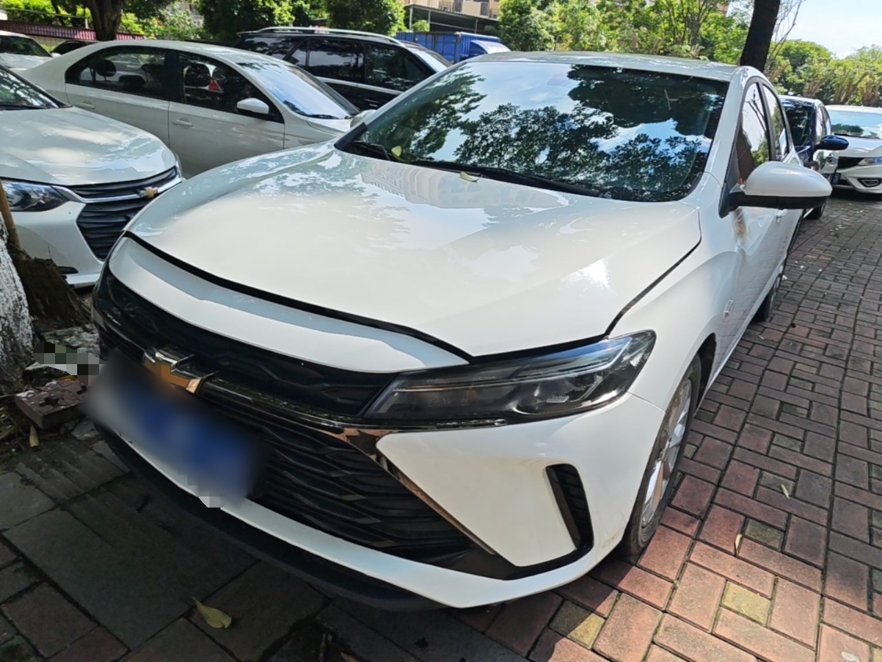 Under the front of the car