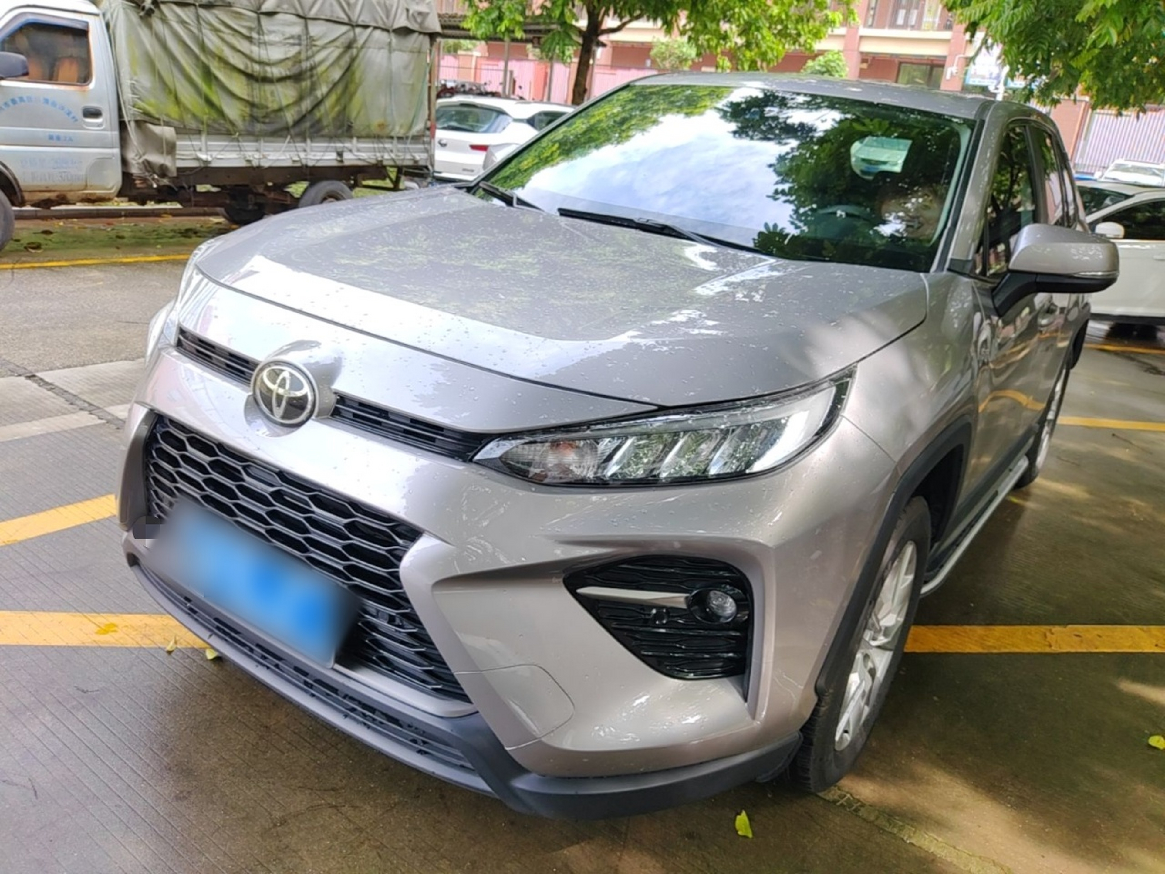 Under the front of the car