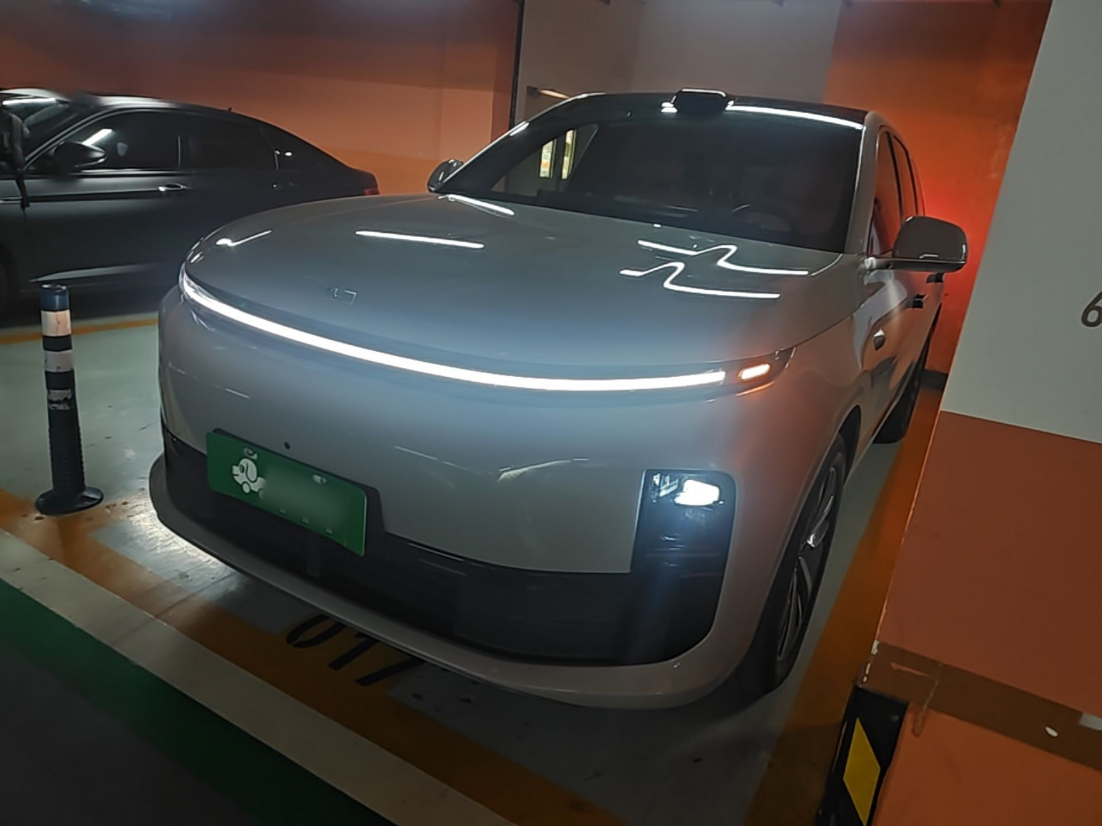Under the front of the car
