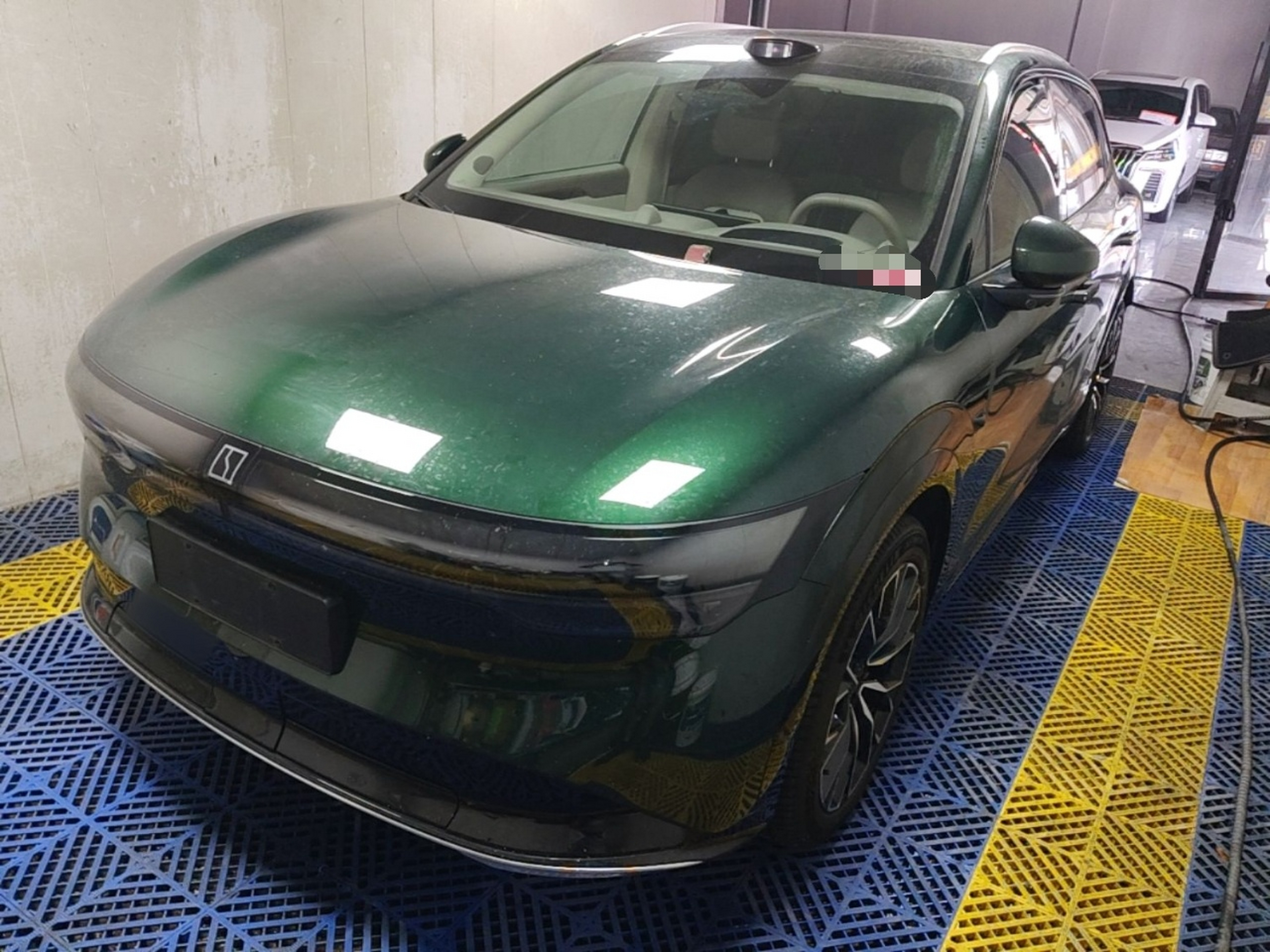 Under the front of the car