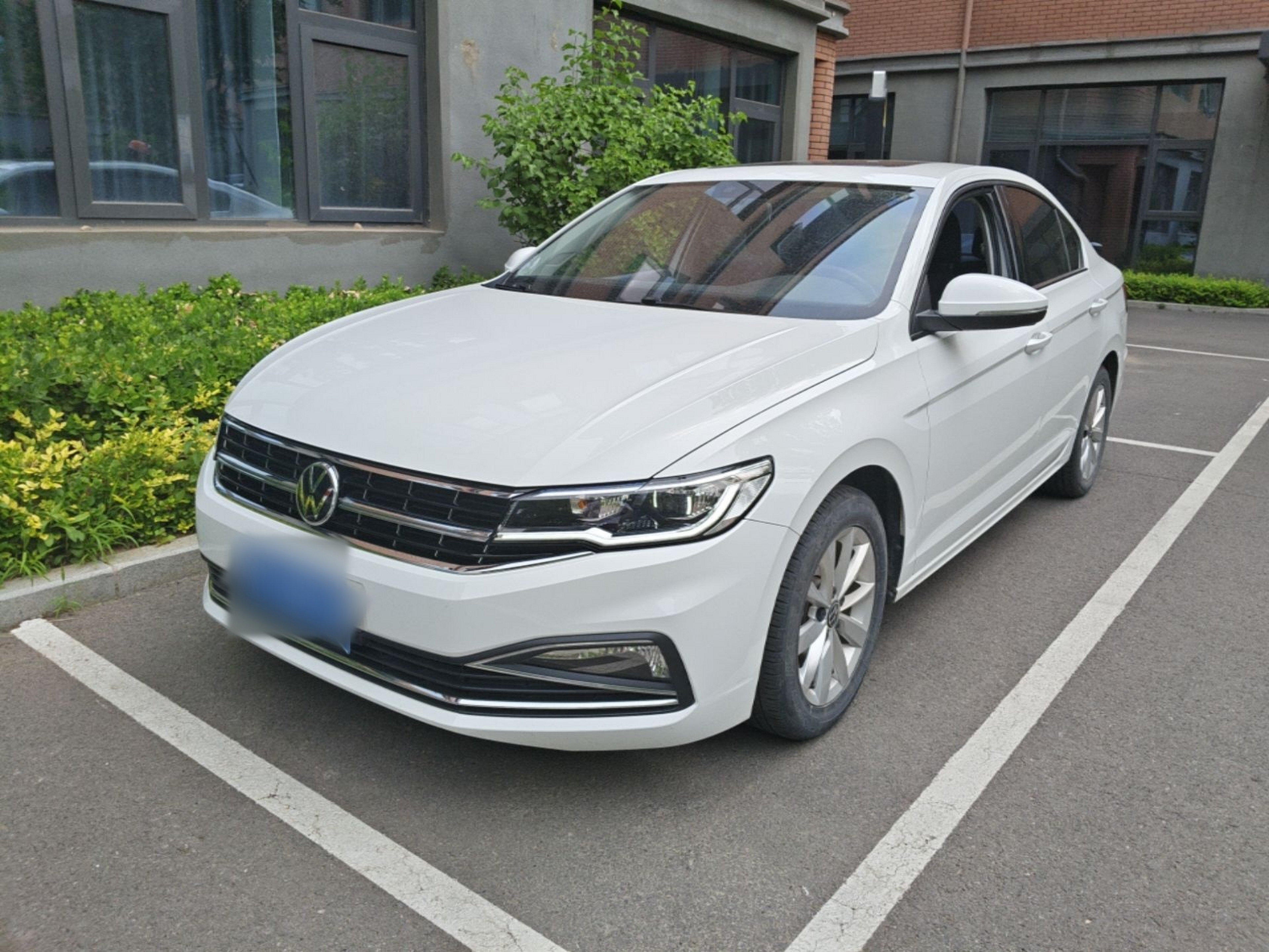 Under the front of the car