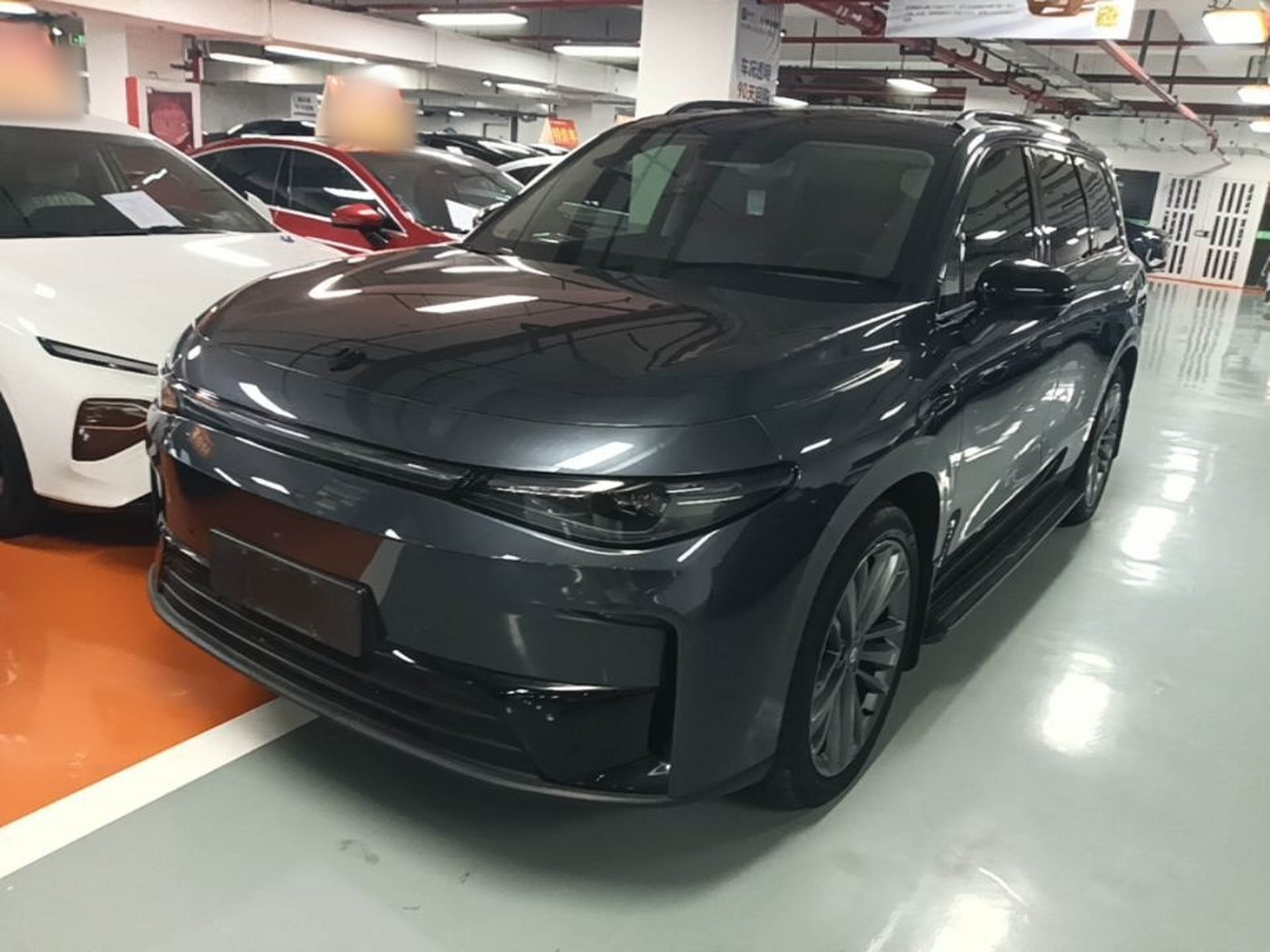 Under the front of the car