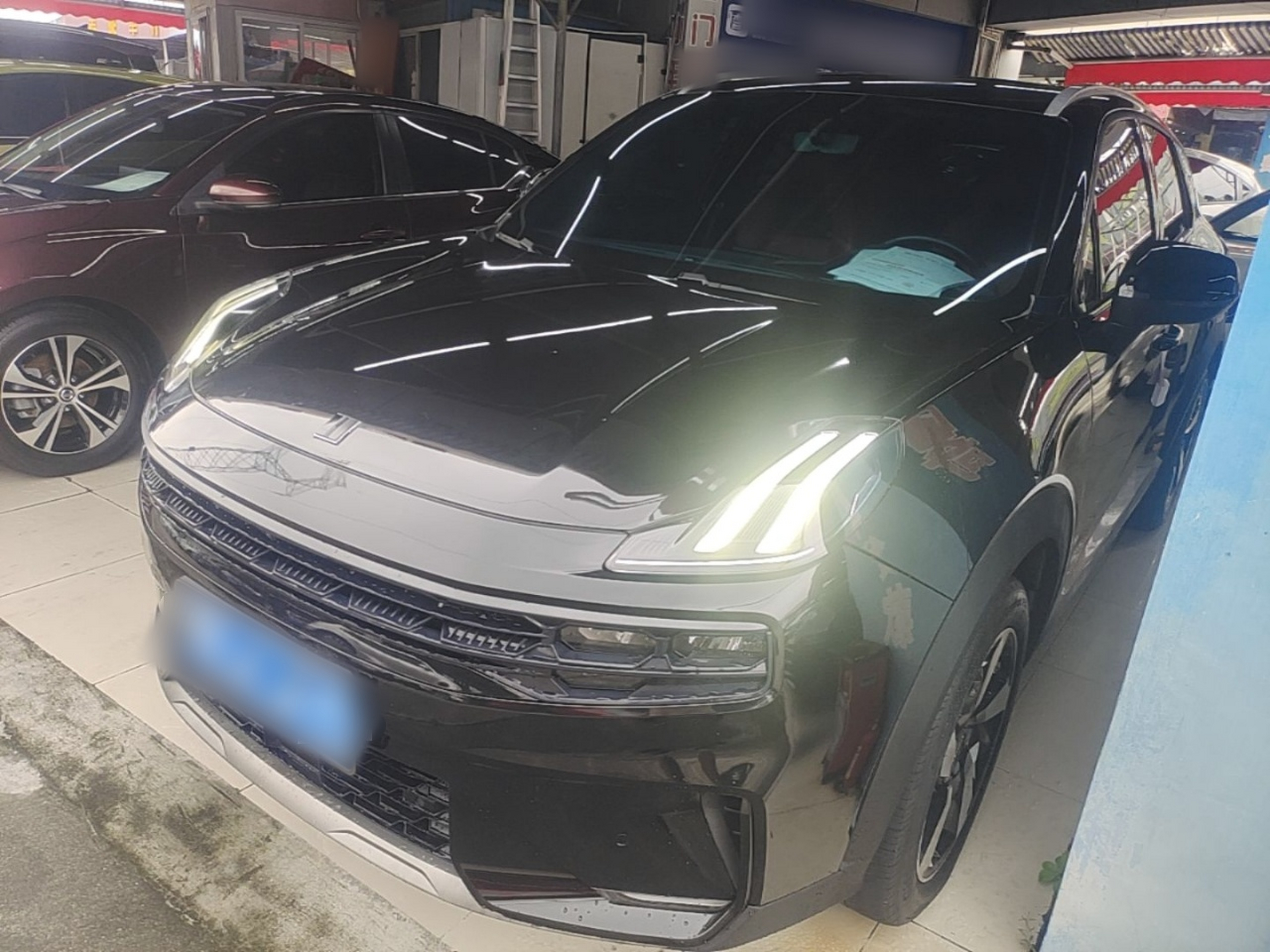 Under the front of the car