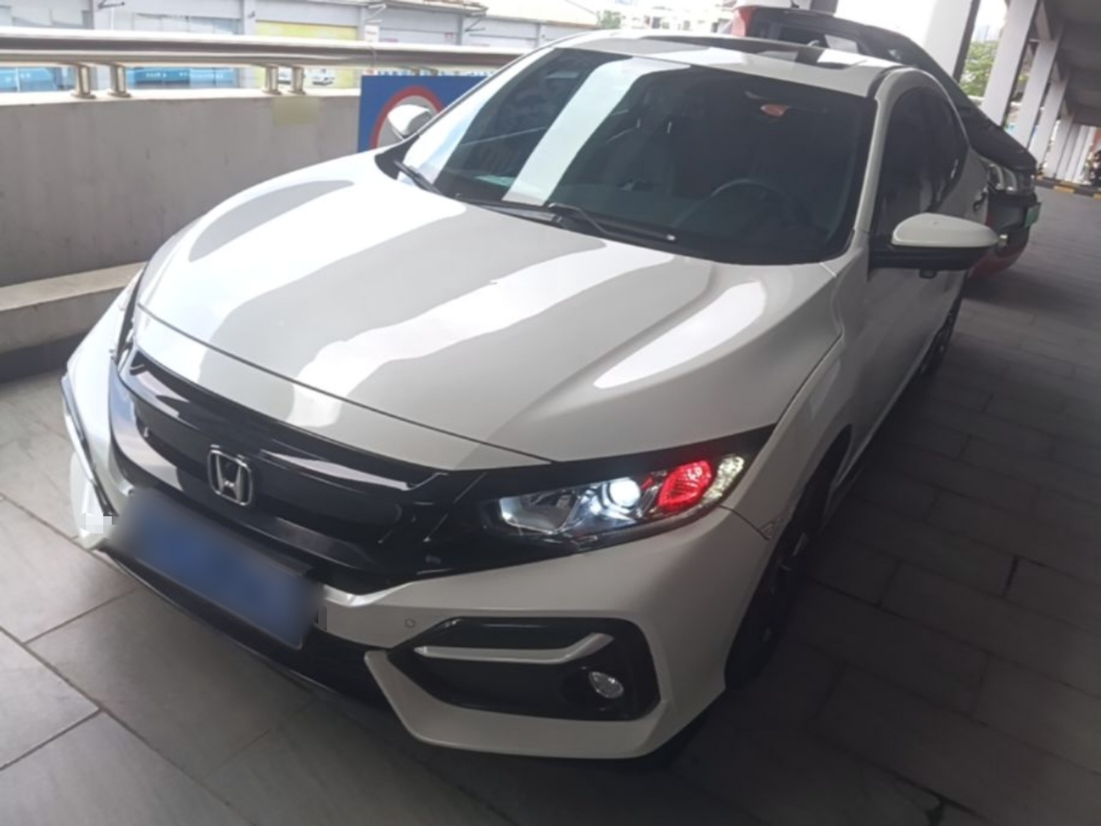 Under the front of the car