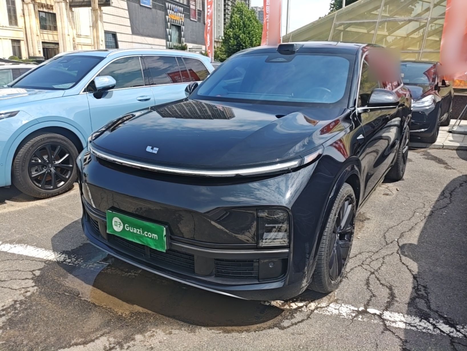 Under the front of the car