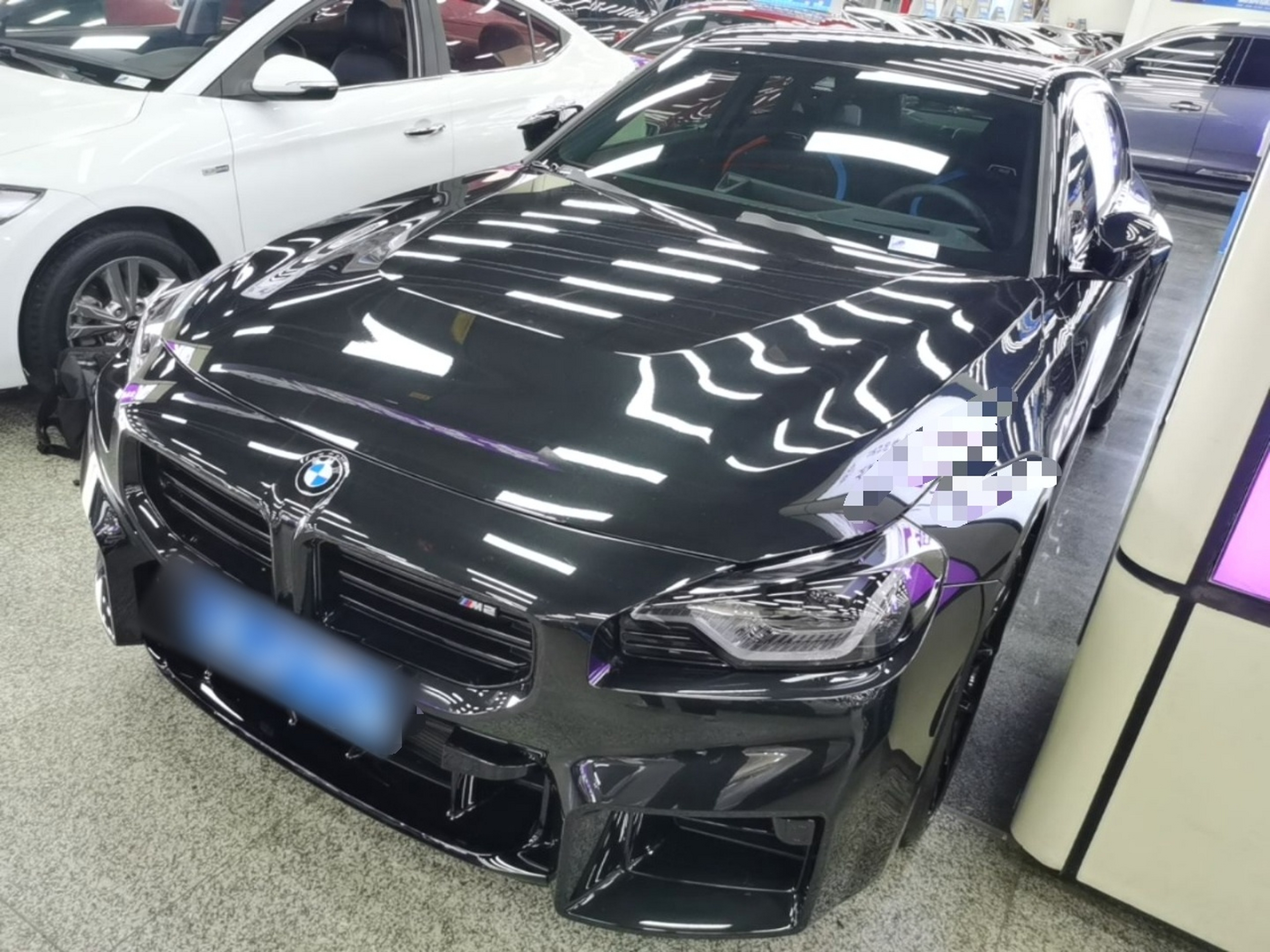 Under the front of the car