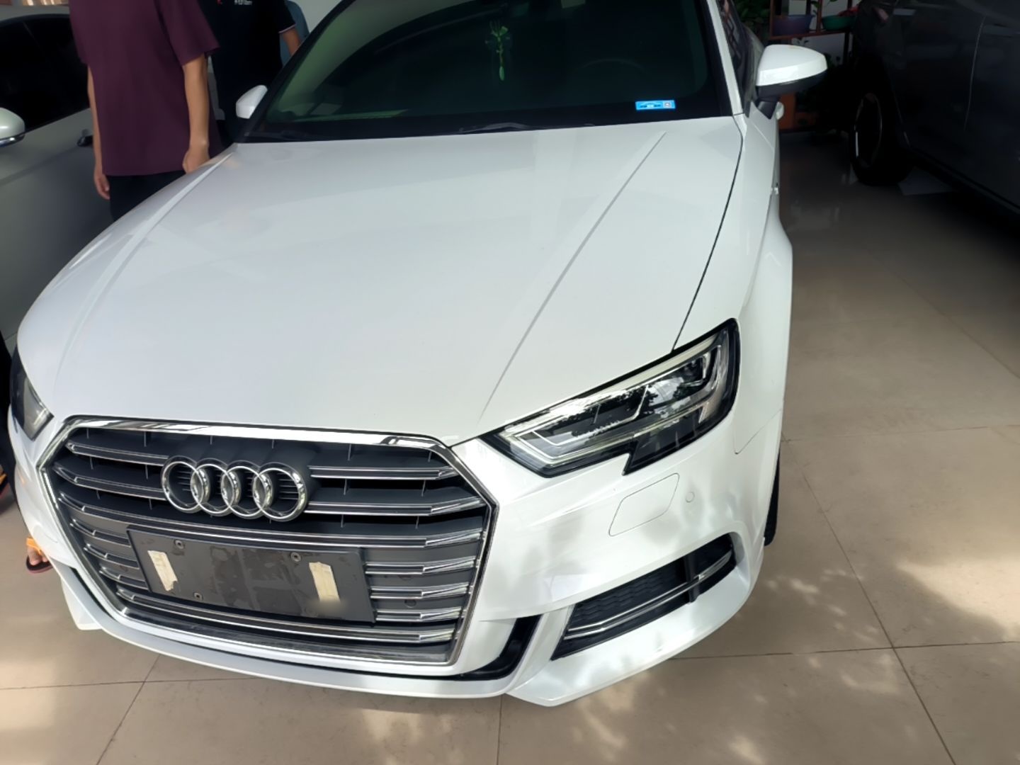 Under the front of the car