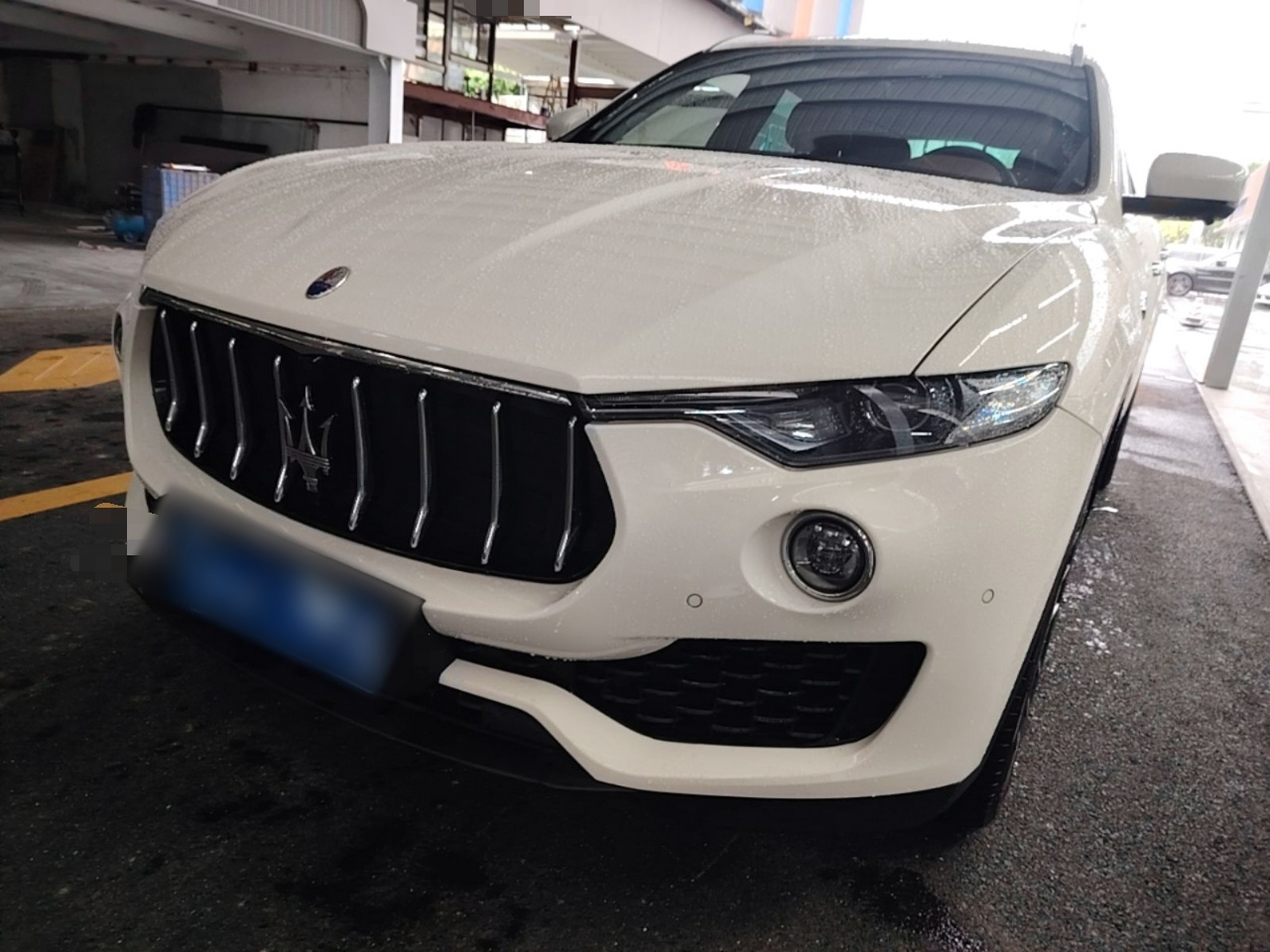 Under the front of the car