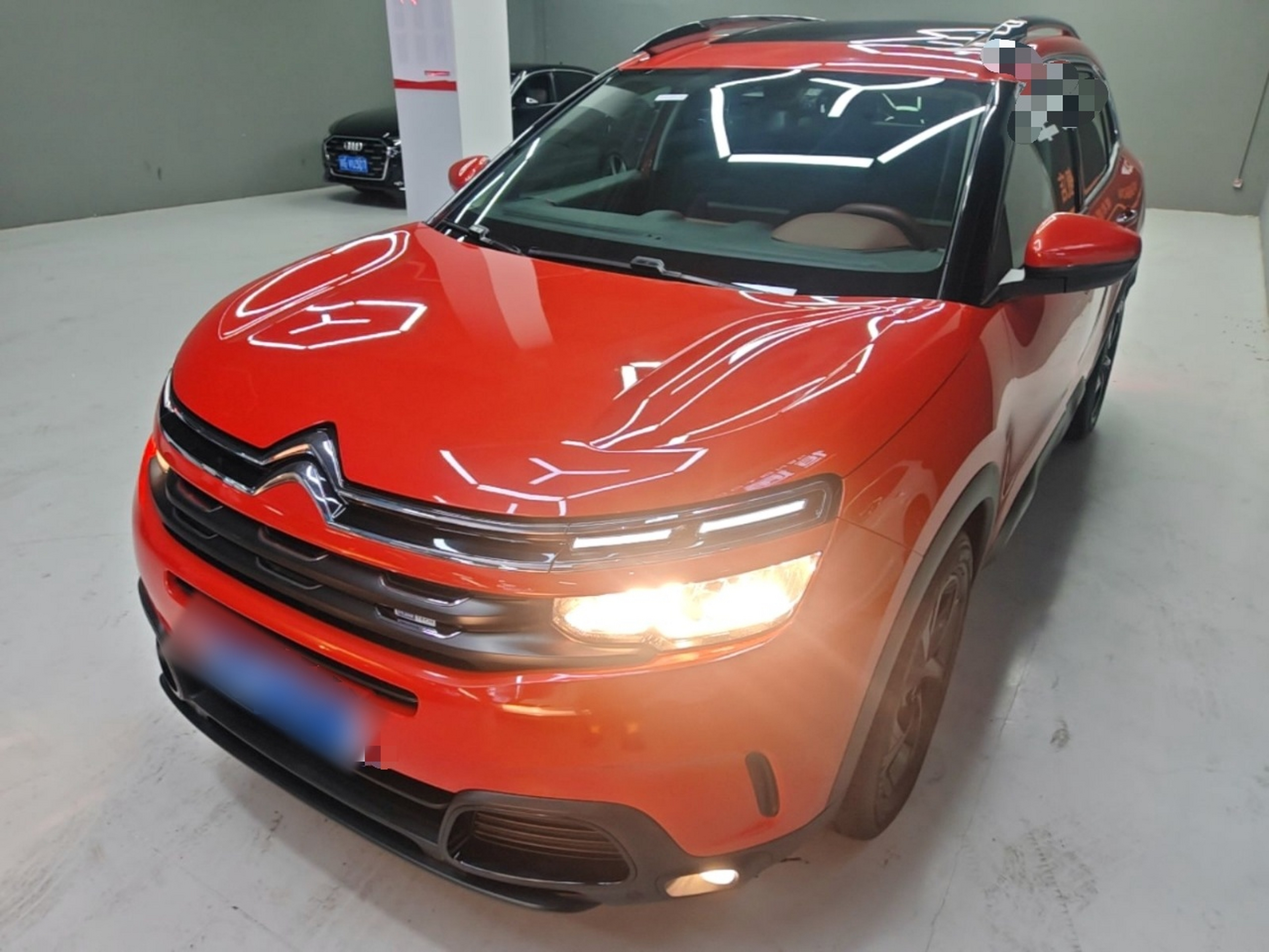 Under the front of the car