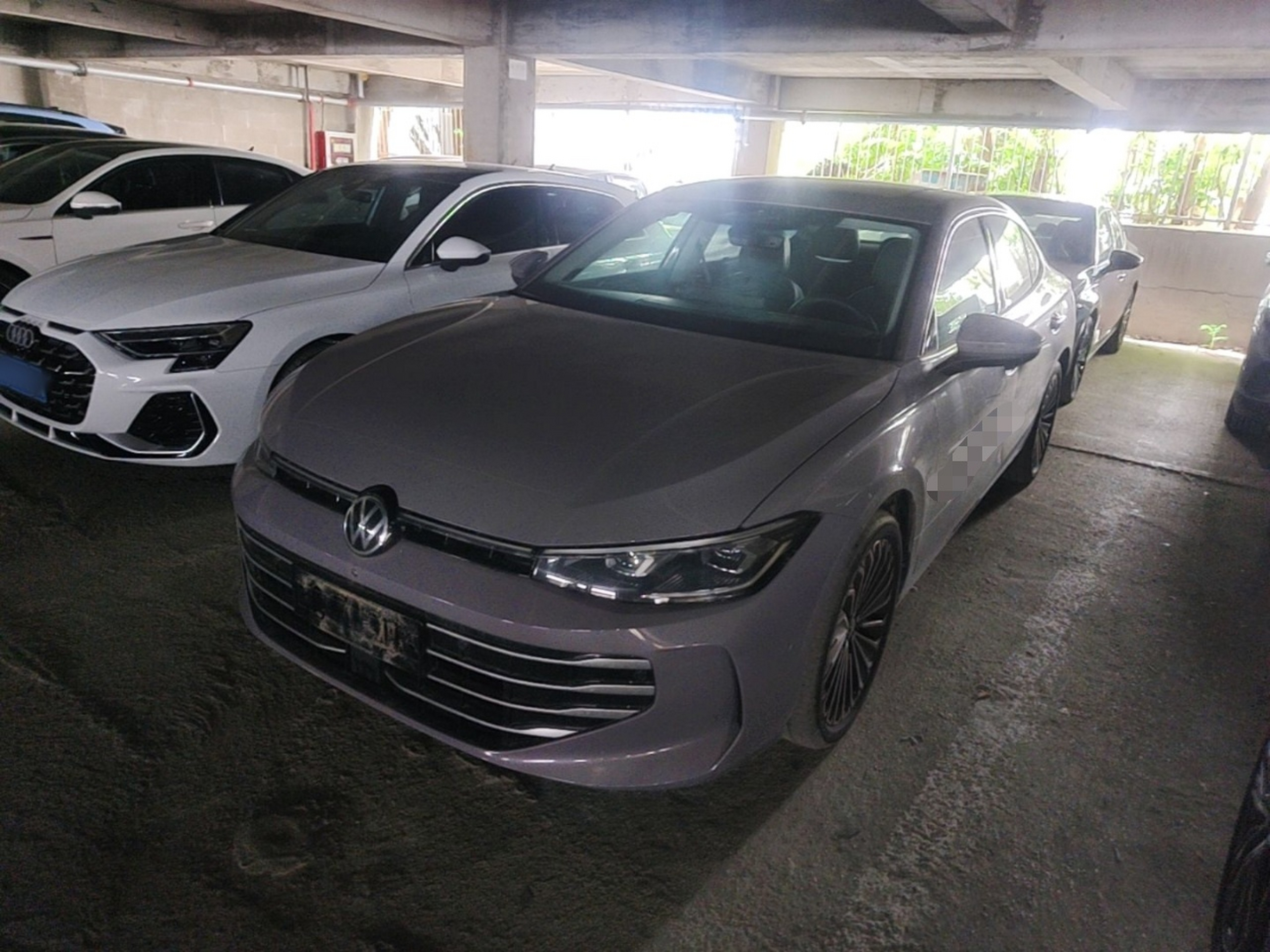 Under the front of the car