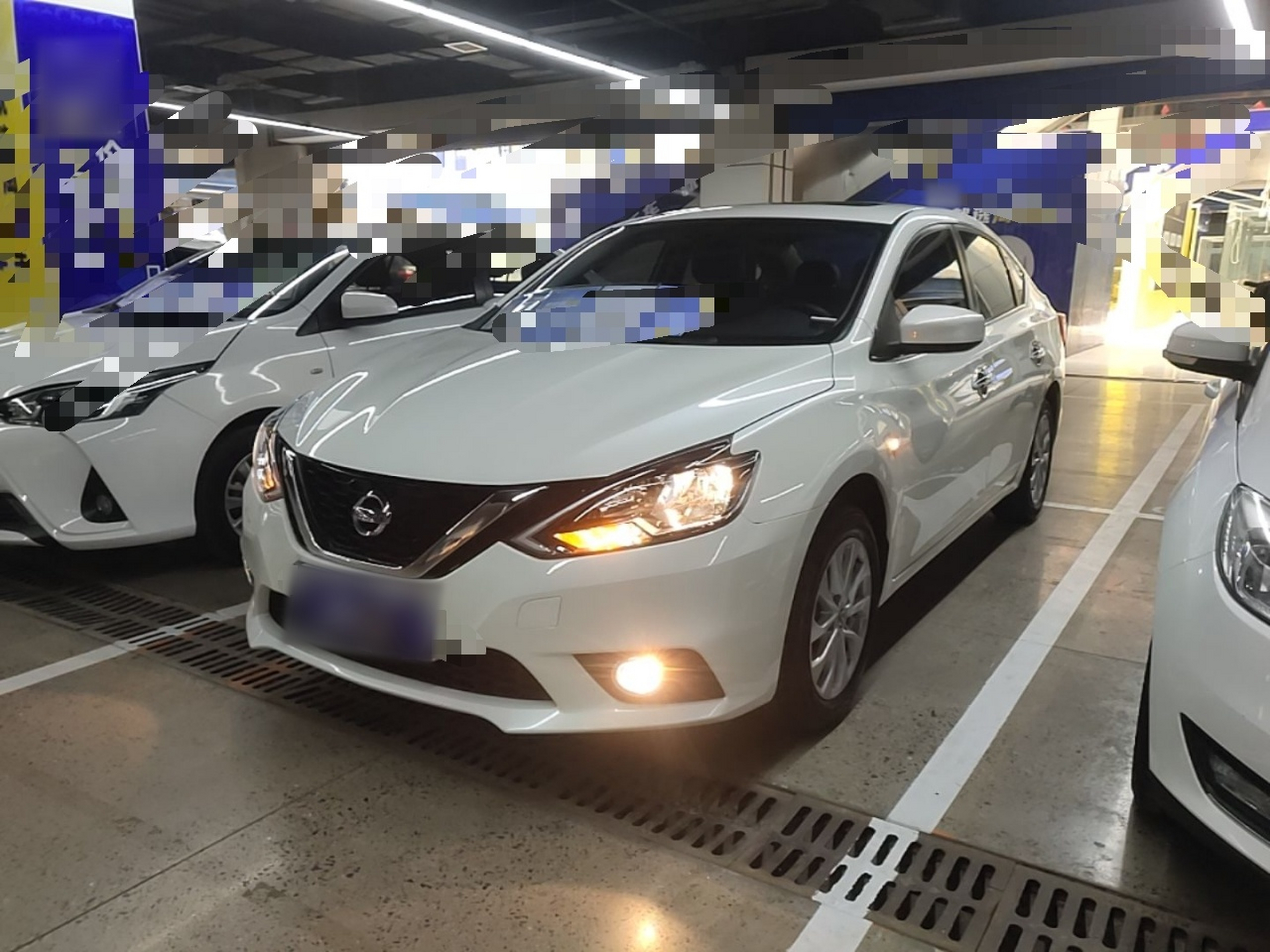 Under the front of the car