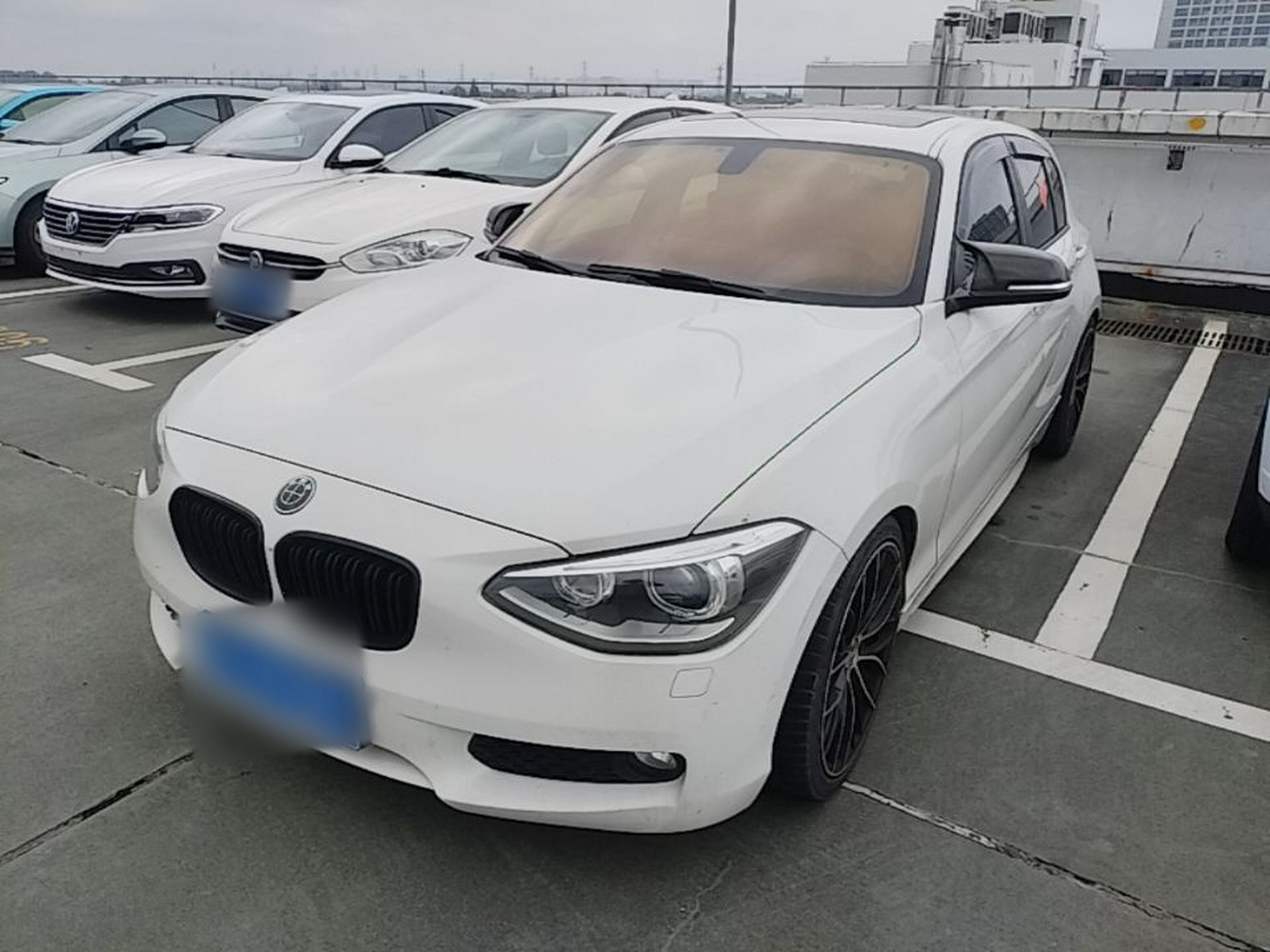 Under the front of the car