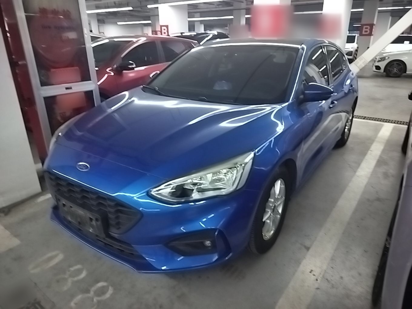 Under the front of the car