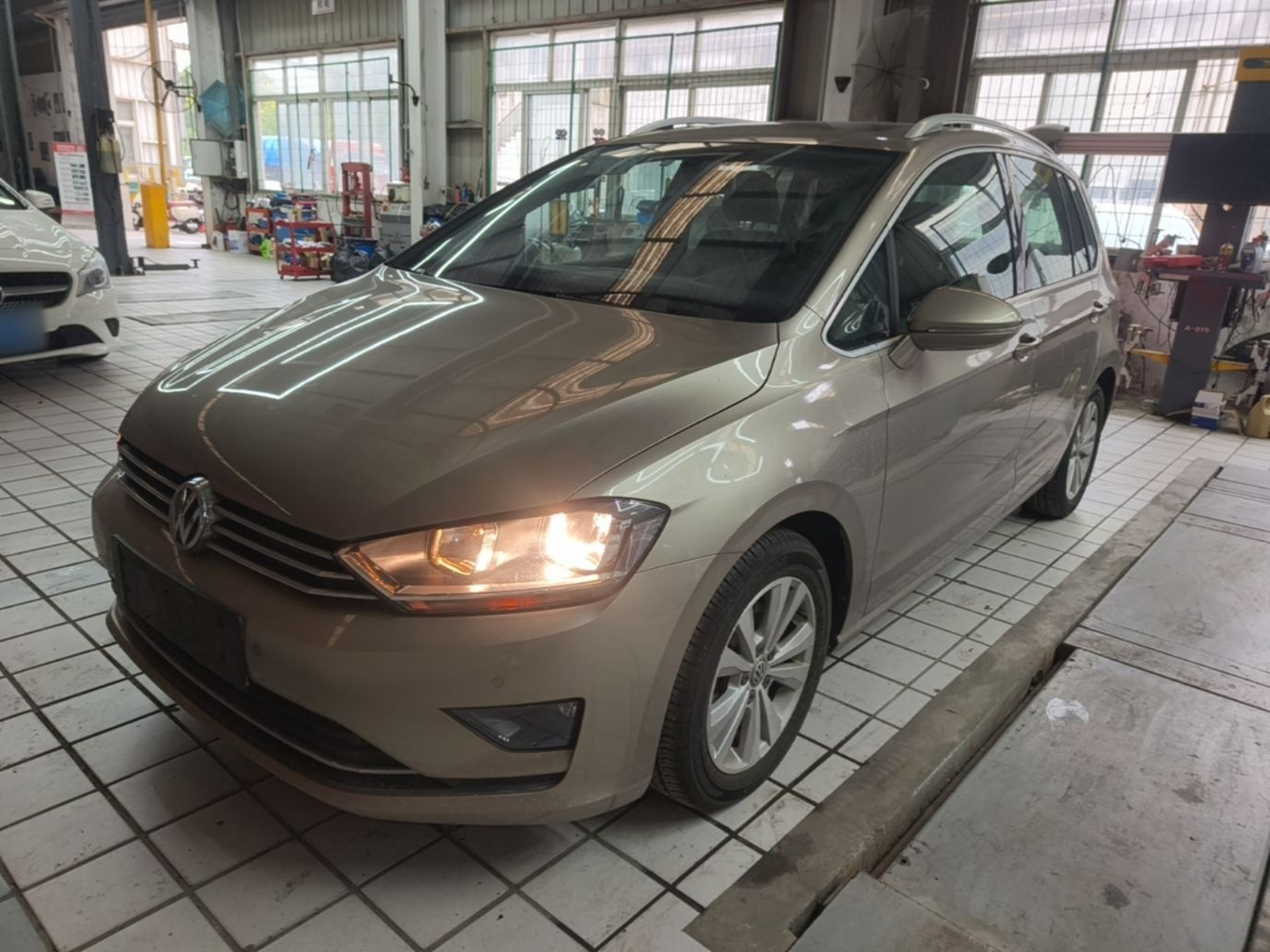 Under the front of the car