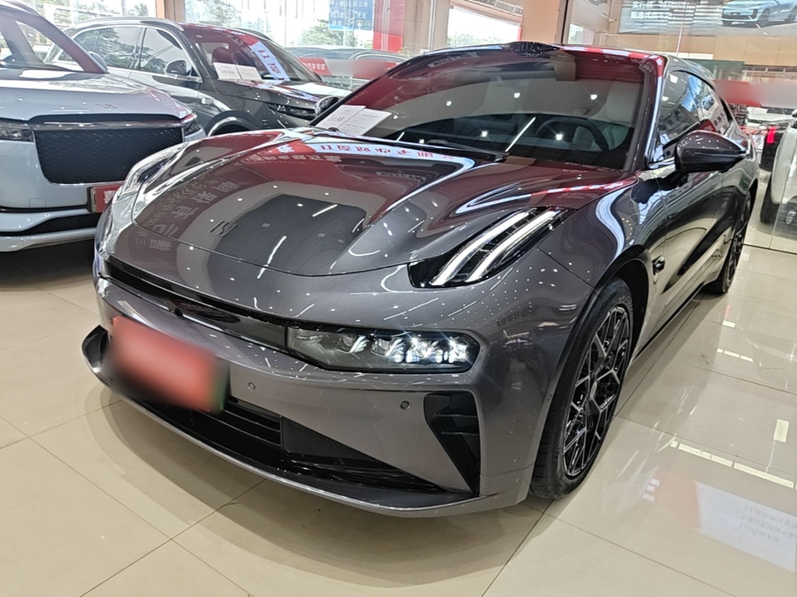 Under the front of the car