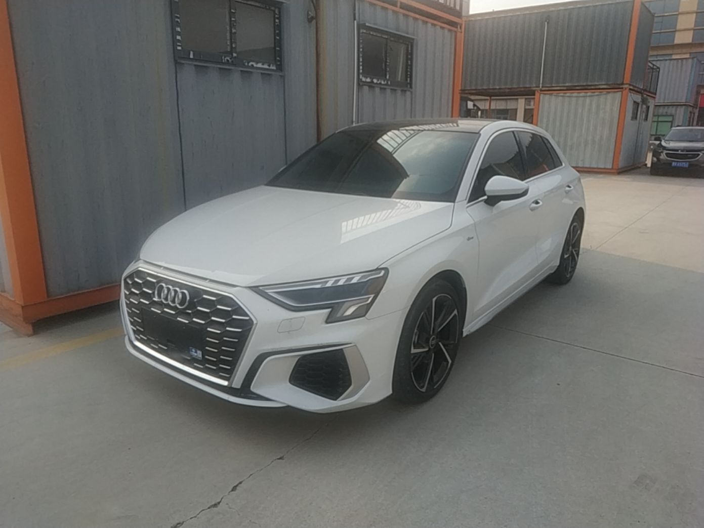 Under the front of the car