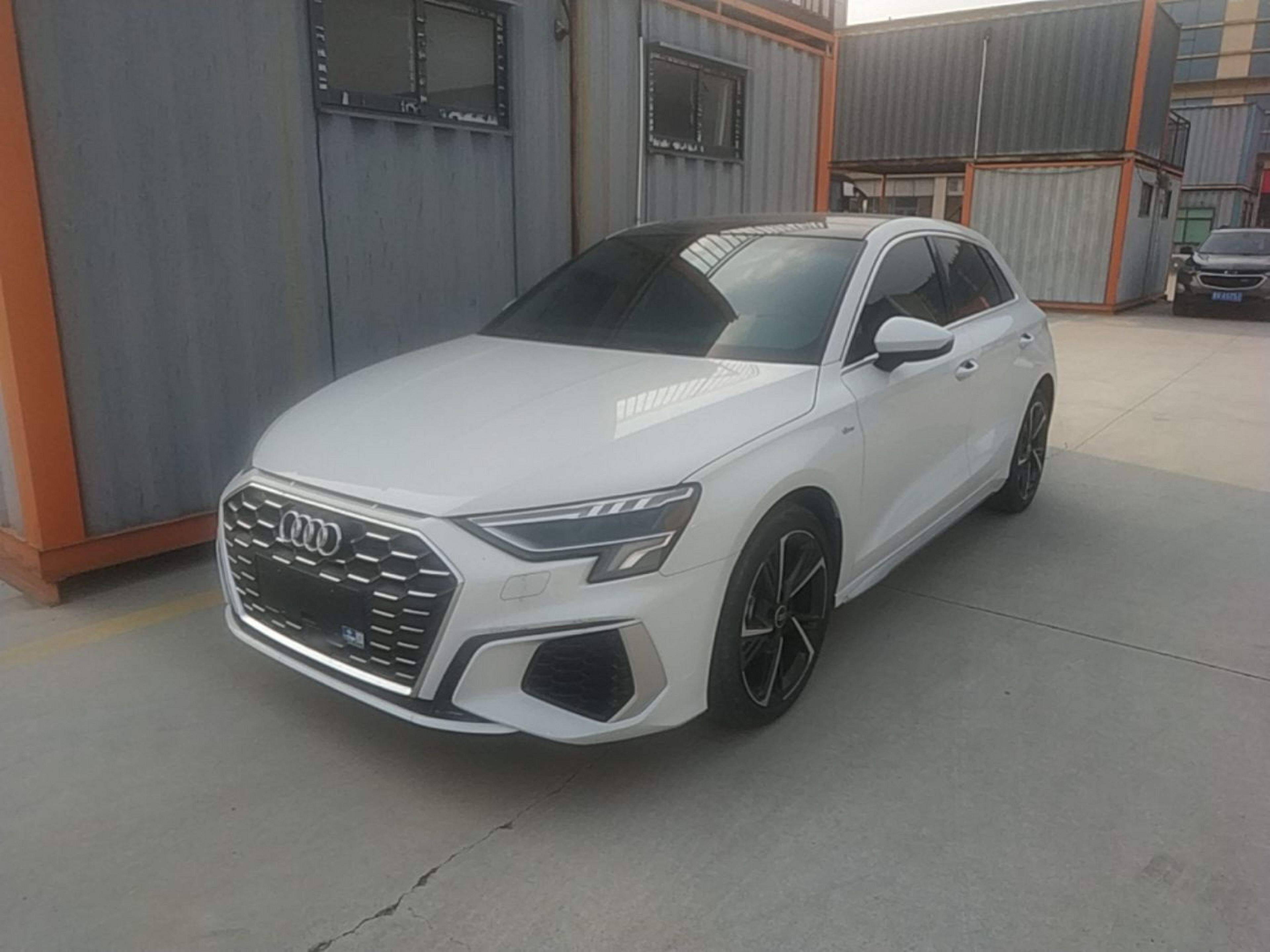 Under the front of the car