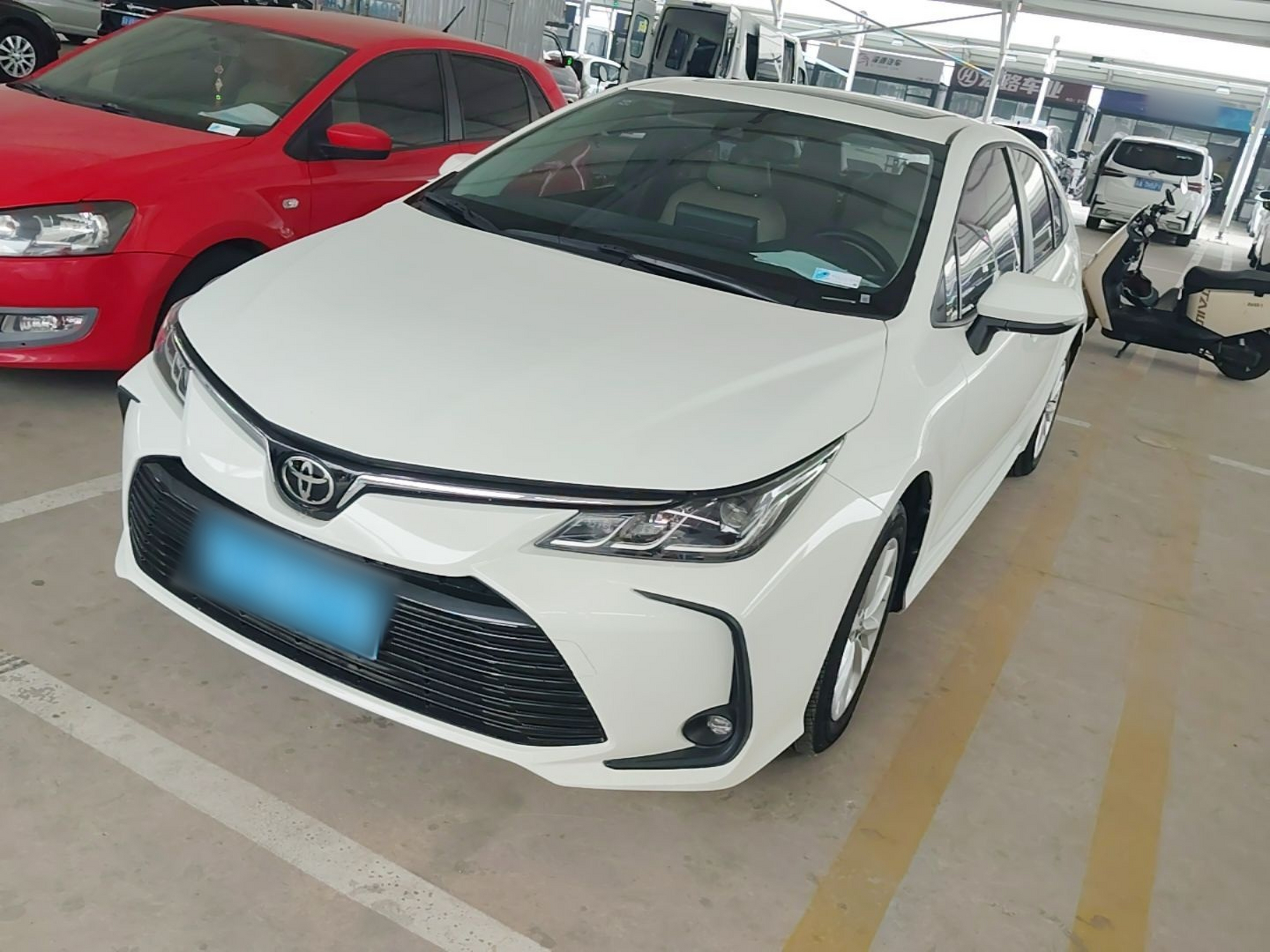 Under the front of the car