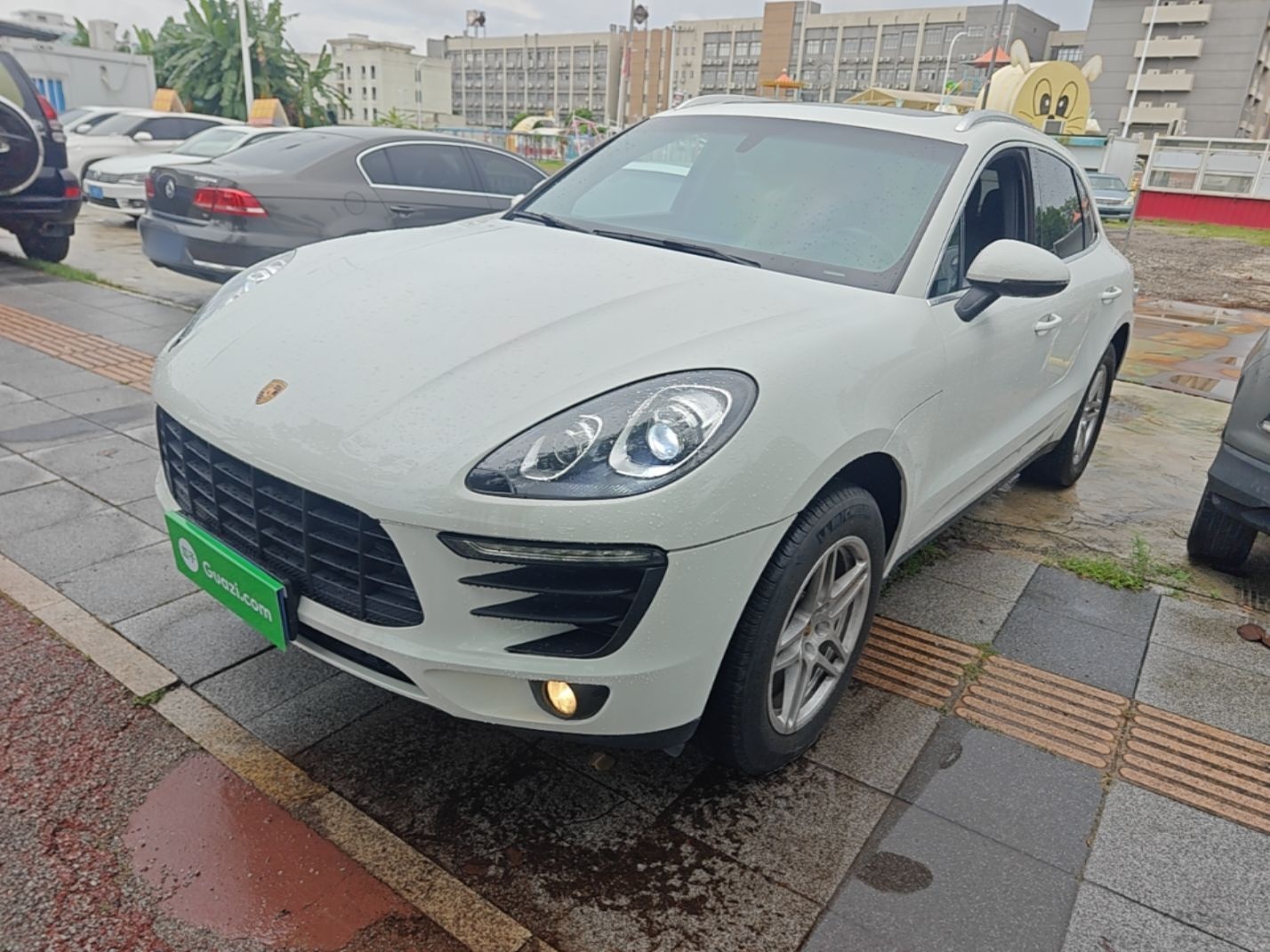 Under the front of the car