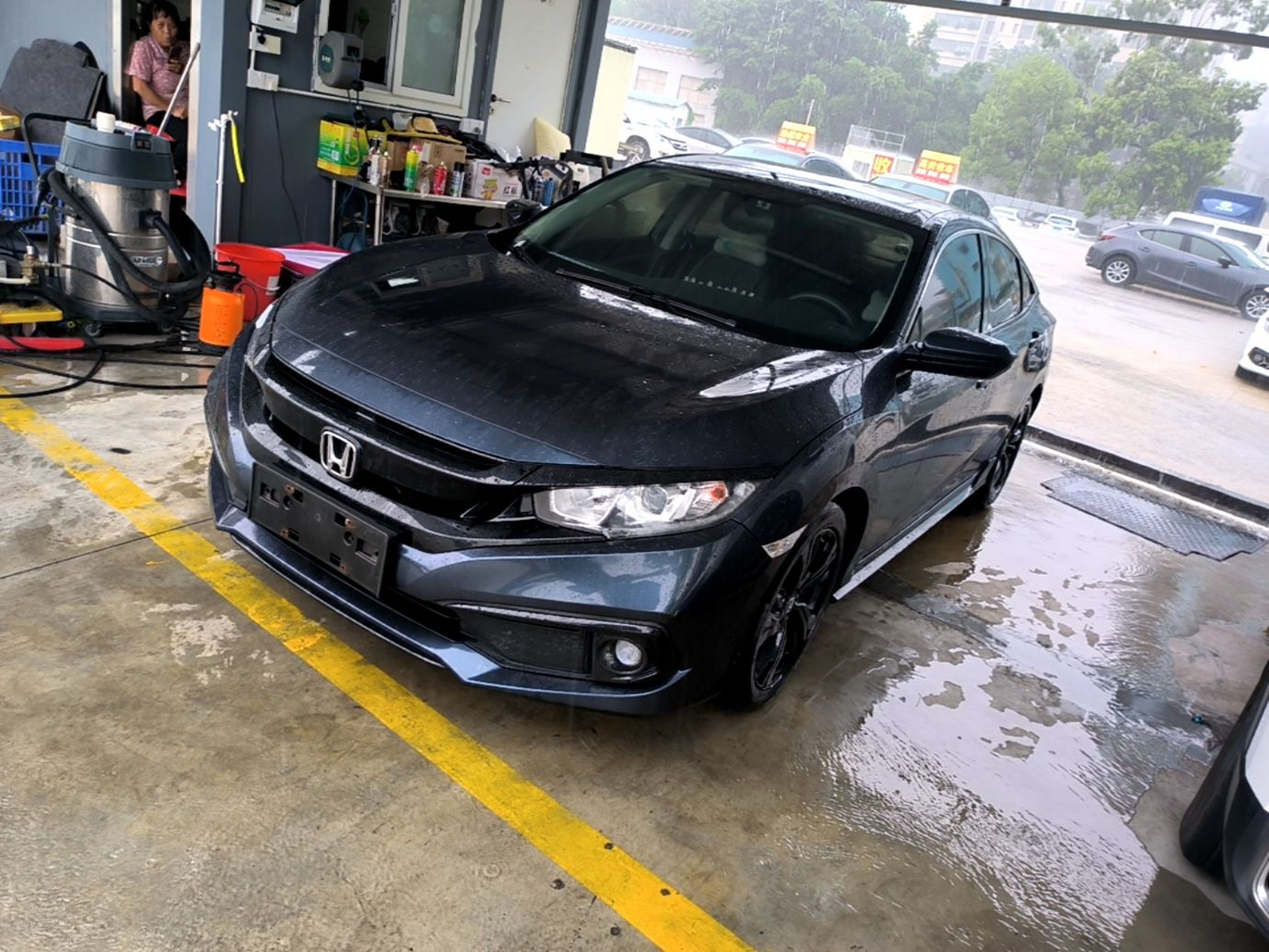 Under the front of the car
