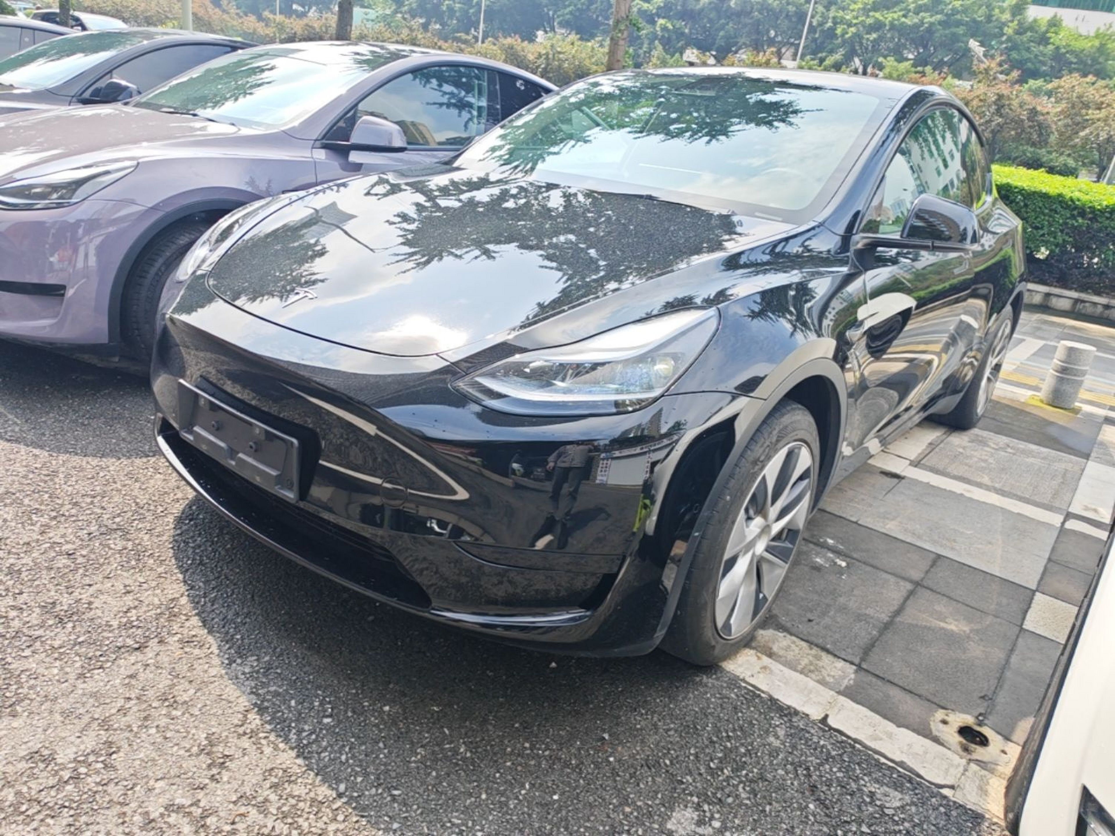 Under the front of the car
