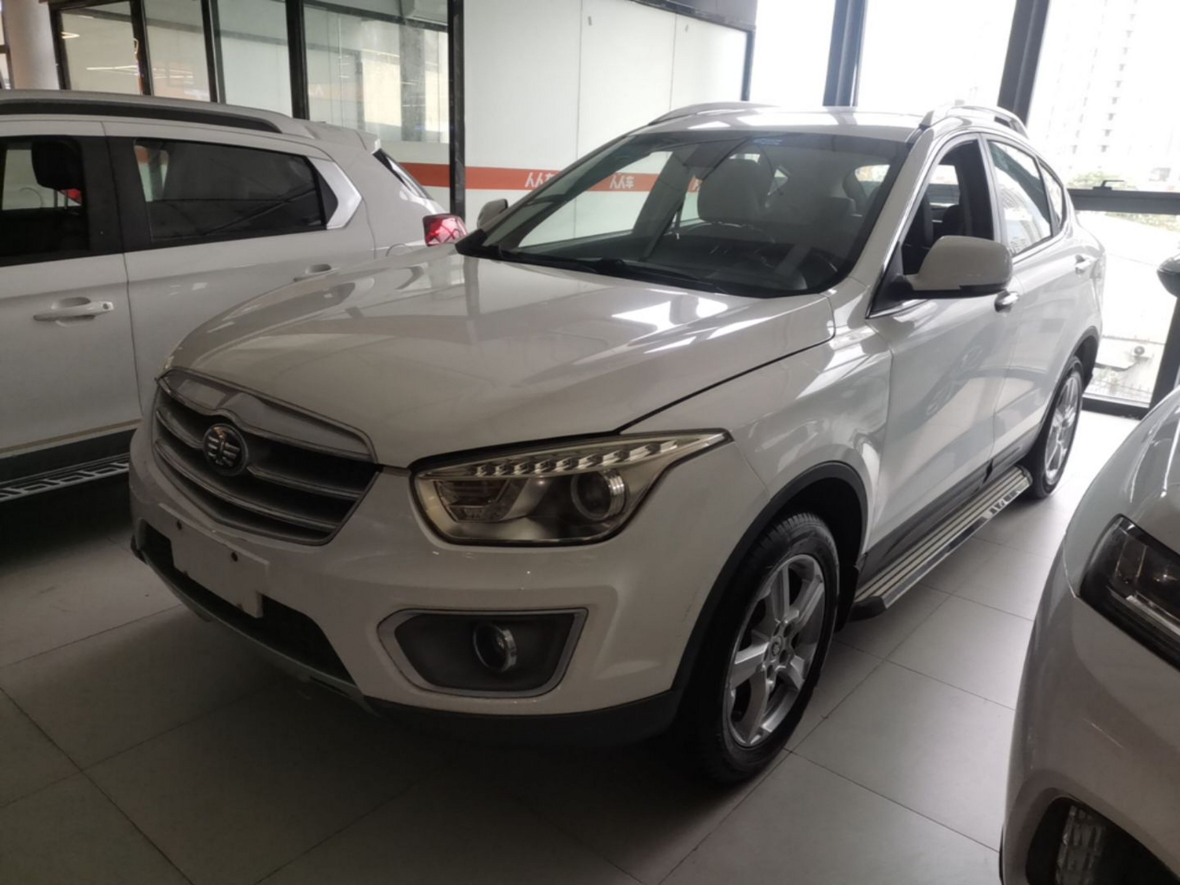 Under the front of the car