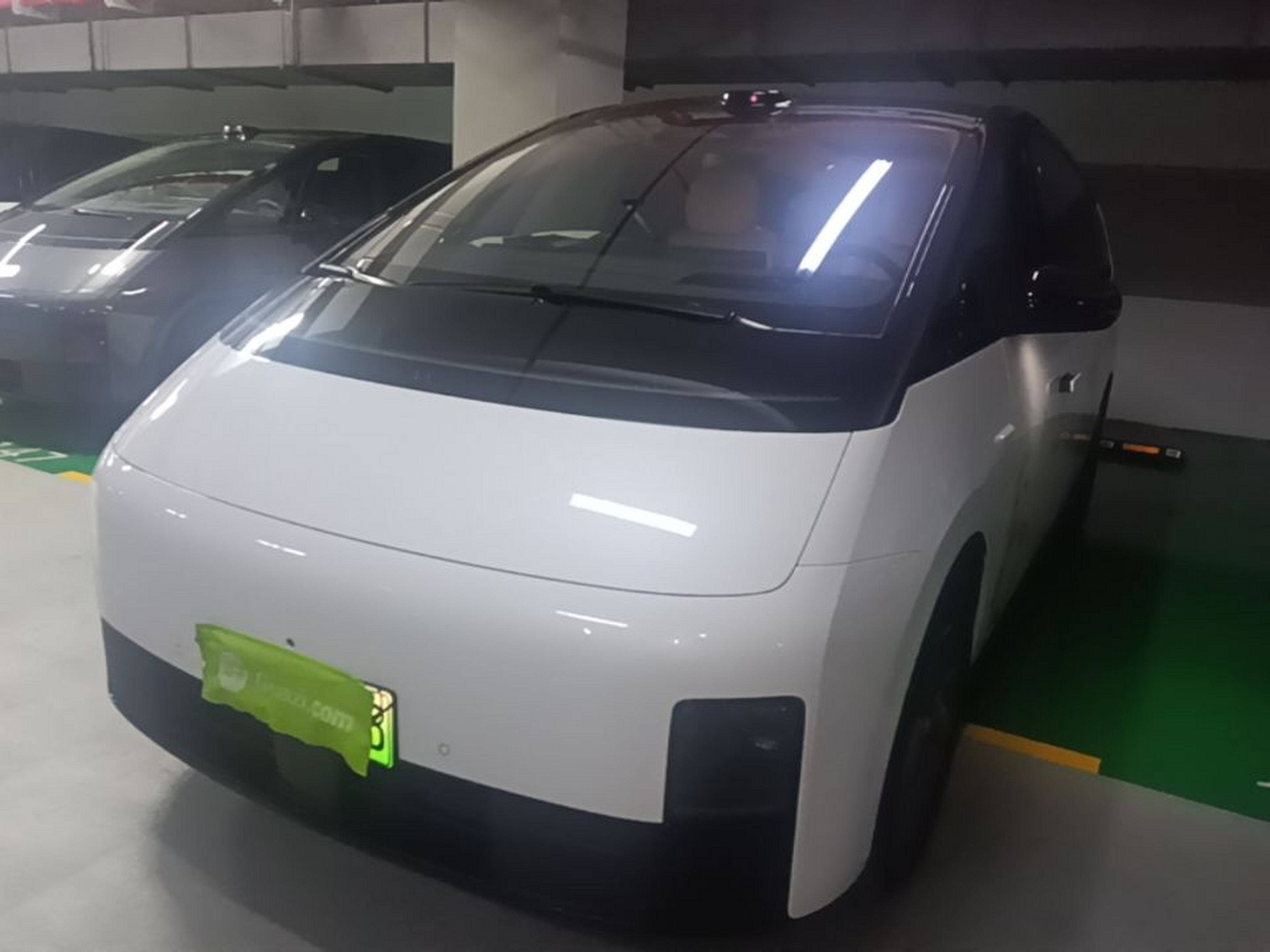 Under the front of the car