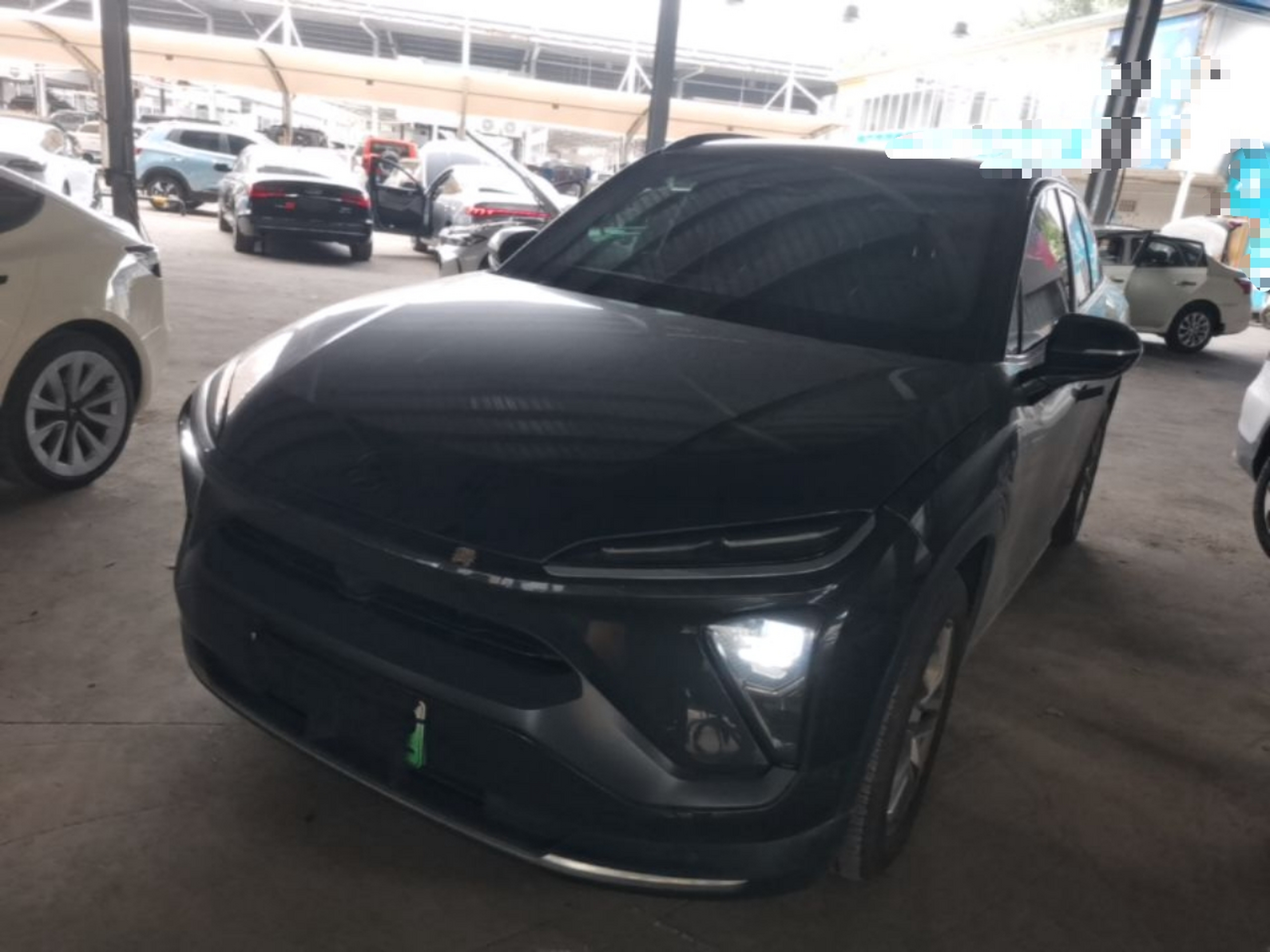 Under the front of the car
